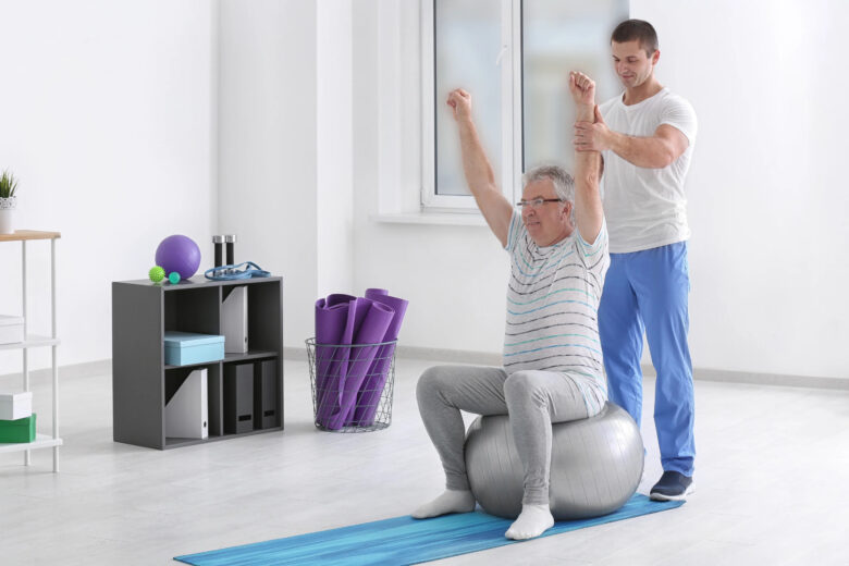 Physiotherapist Working with Senior Patient in Modern Clinic